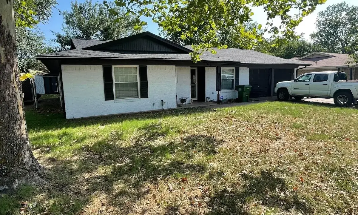 Professional roofing crew working on a residential roof in Mattoon